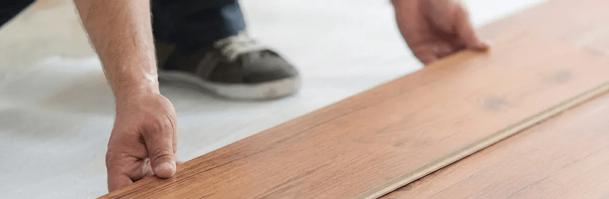 A professional installing laminate flooring in Peoria, IL