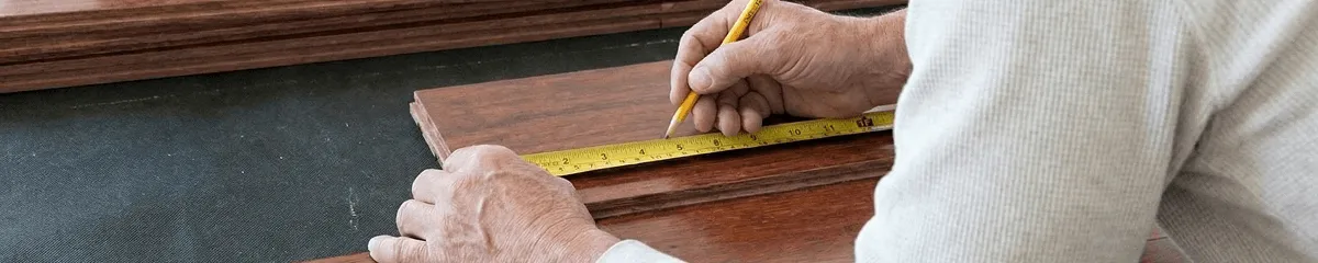 A professional installing wood flooring in Peoria, IL